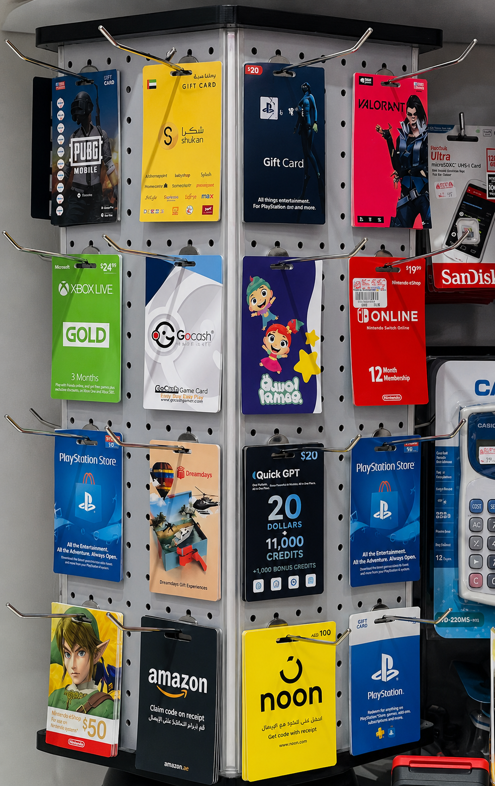 QuickGPT gift card hanging on a peg-hook retail rack next to Valorant and Nintendo eShop cards